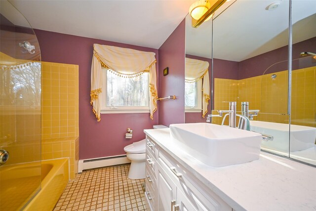 full bathroom featuring vanity, tiled shower / bath combo, a baseboard radiator, tile patterned flooring, and toilet