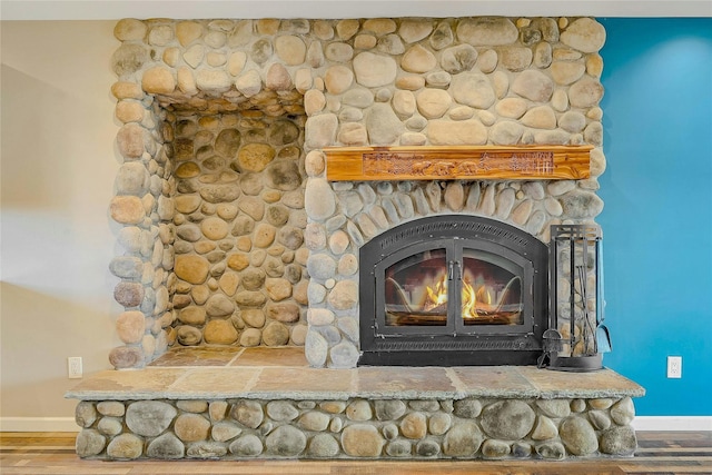 details with a fireplace and wood-type flooring