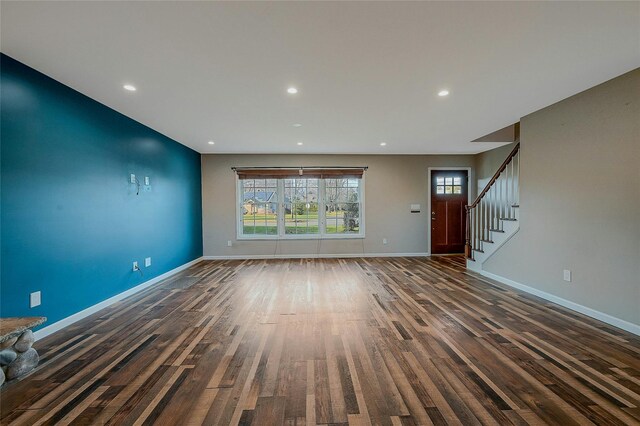 unfurnished living room with dark hardwood / wood-style floors