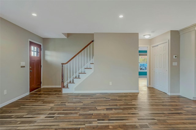 foyer entrance featuring a wealth of natural light and dark wood-type flooring