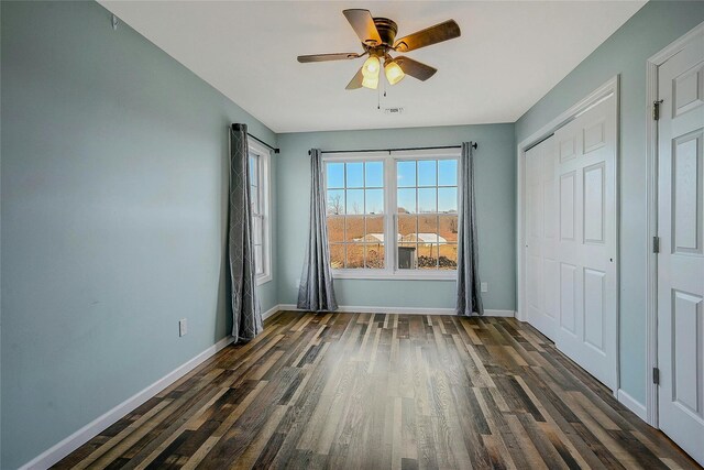 interior space with ceiling fan and dark hardwood / wood-style flooring