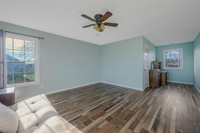 unfurnished living room with ceiling fan and dark hardwood / wood-style flooring