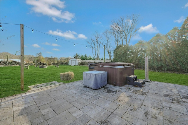 view of patio featuring a storage shed and a hot tub