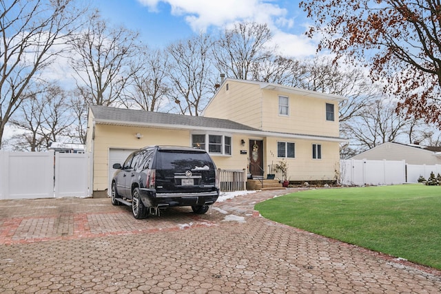 view of front of house with a garage and a front lawn