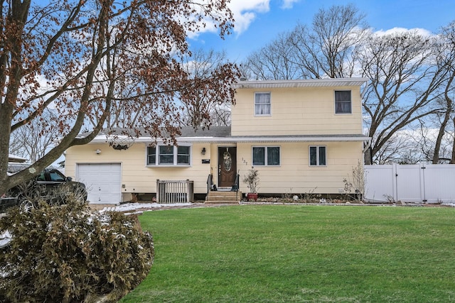 view of front of house with a garage and a front yard