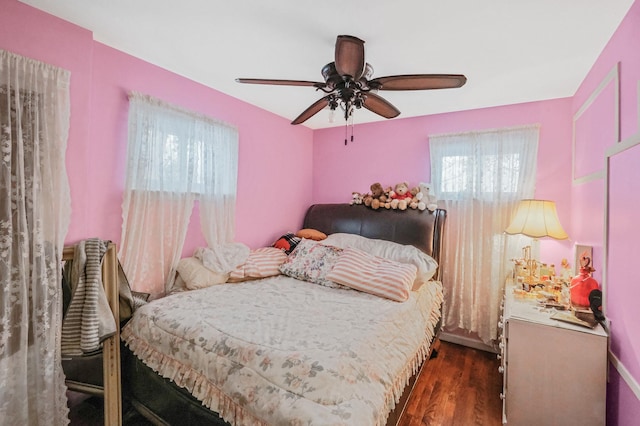 bedroom featuring dark hardwood / wood-style flooring and ceiling fan