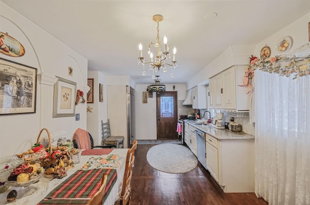 kitchen featuring white cabinetry, decorative light fixtures, a chandelier, stainless steel dishwasher, and dark hardwood / wood-style floors