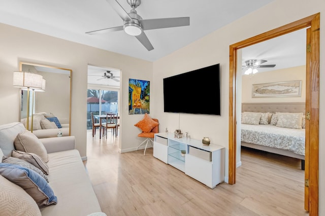 living room with ceiling fan and light hardwood / wood-style floors