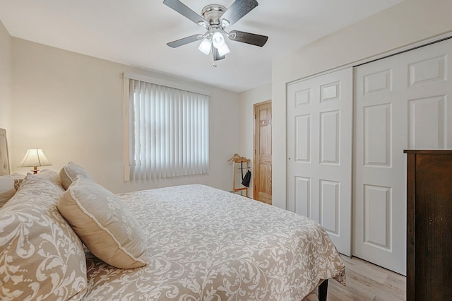 bedroom with light wood-type flooring, a closet, and ceiling fan