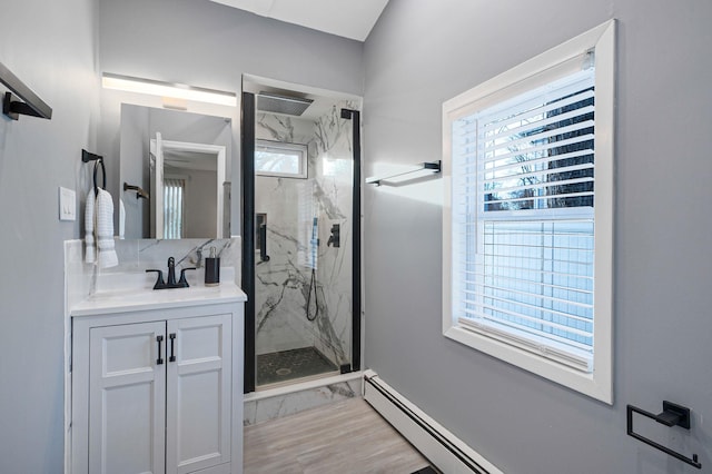 bathroom featuring vanity, a baseboard radiator, and an enclosed shower