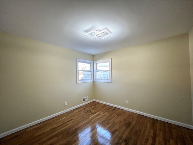 spare room with dark hardwood / wood-style floors