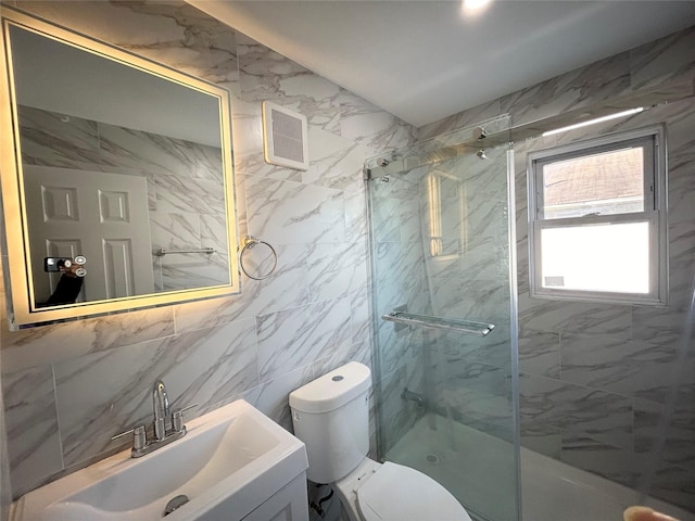 bathroom featuring toilet, an enclosed shower, and vanity