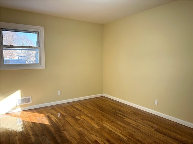 spare room with wood-type flooring