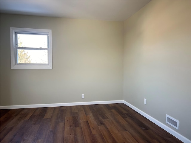 spare room with dark wood-type flooring