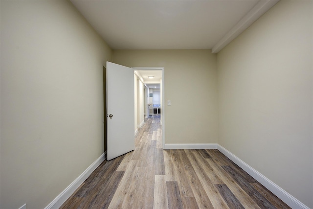 corridor with light hardwood / wood-style floors