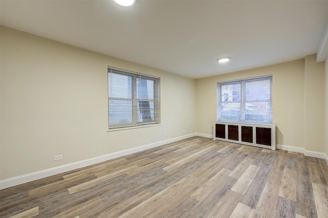 empty room with hardwood / wood-style flooring