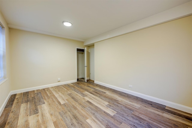 unfurnished bedroom featuring a closet and light wood-type flooring