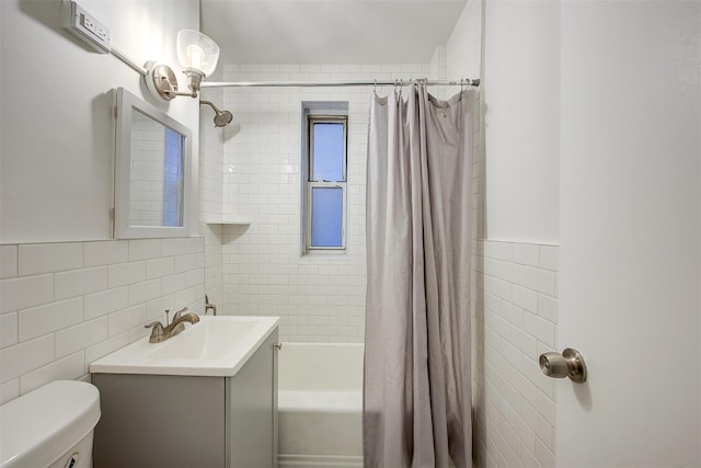 full bathroom with vanity, shower / bathtub combination with curtain, toilet, and tile walls