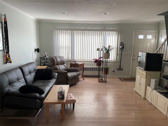 living room with radiator, light hardwood / wood-style floors, and ornamental molding