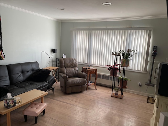 living room featuring light wood-type flooring, ornamental molding, and radiator