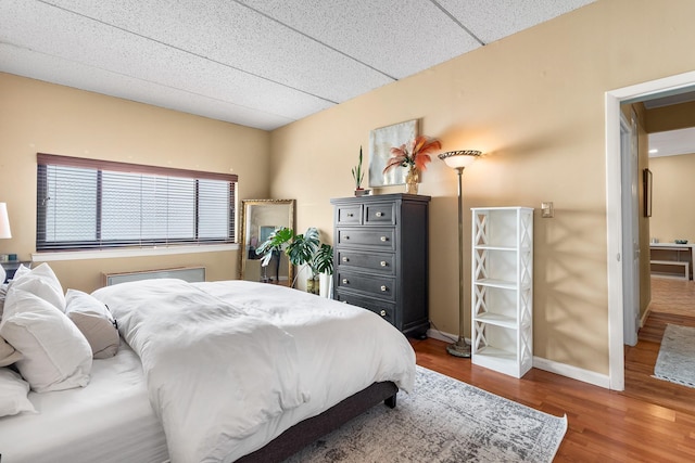 bedroom with dark hardwood / wood-style floors