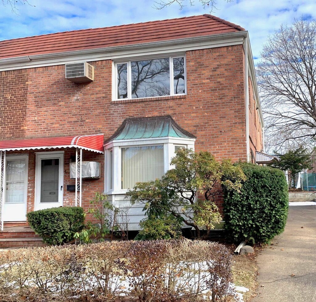 73-05 197th St, Fresh Meadows, NY 11366 - view of front facade featuring a wall mounted air conditioner