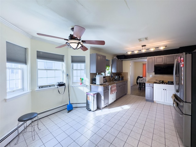 kitchen featuring stainless steel fridge, backsplash, light tile patterned floors, and ceiling fan