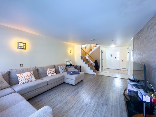 living room featuring hardwood / wood-style flooring and a baseboard heating unit