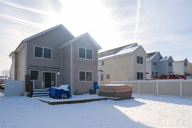 snow covered property featuring a hot tub