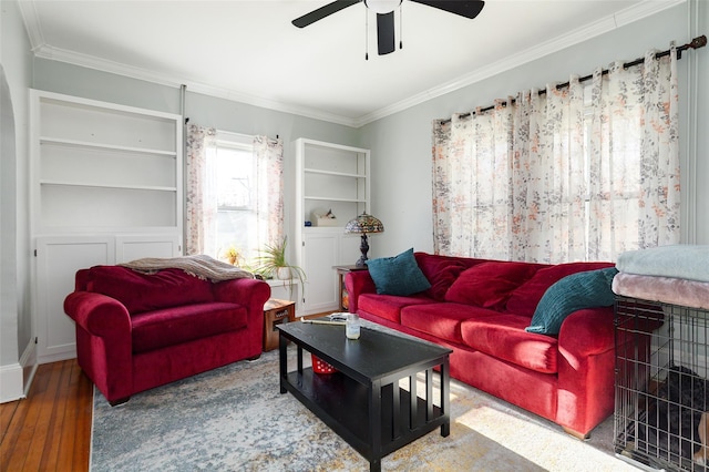 living room featuring ceiling fan, wood-type flooring, and ornamental molding