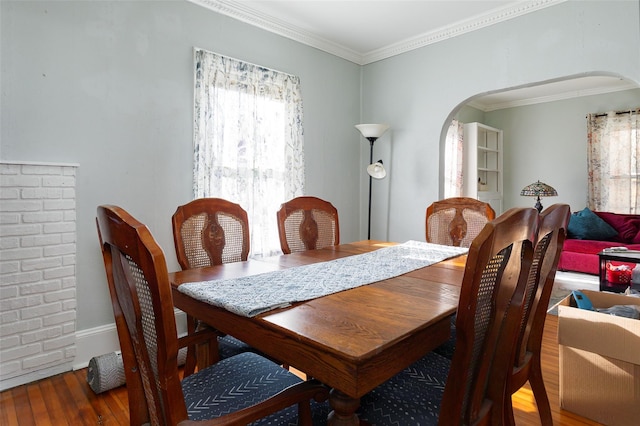 dining space featuring hardwood / wood-style floors and ornamental molding