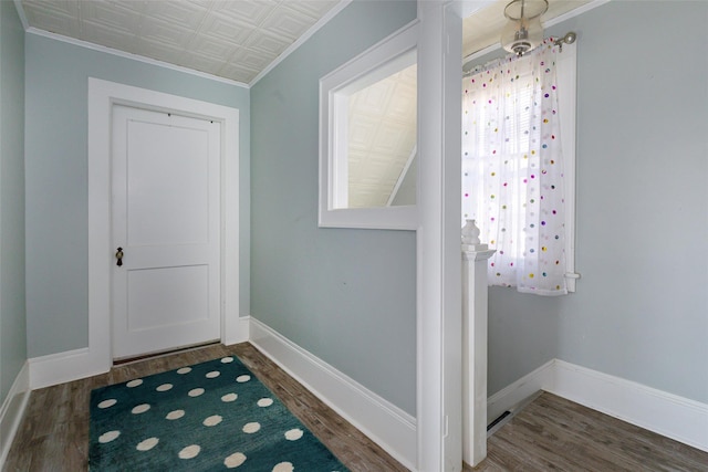 doorway with ornamental molding and dark wood-type flooring