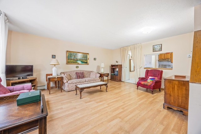 living room with light hardwood / wood-style floors and baseboard heating