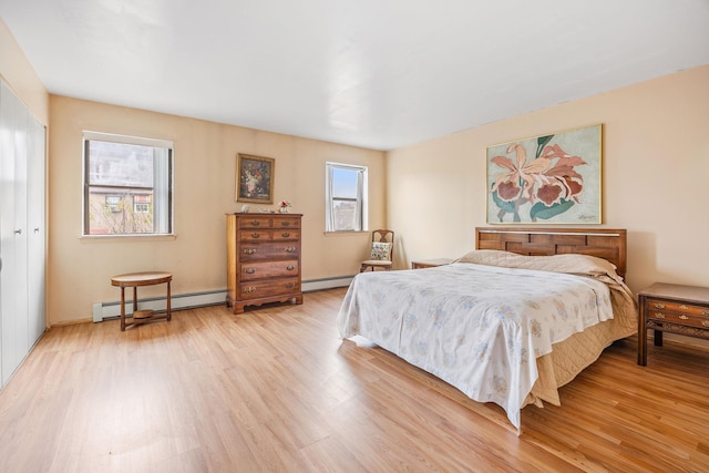 bedroom featuring light wood-type flooring and baseboard heating