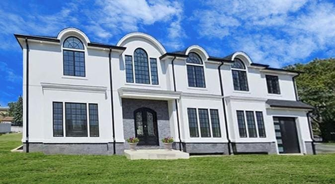 view of front facade with a front yard and french doors