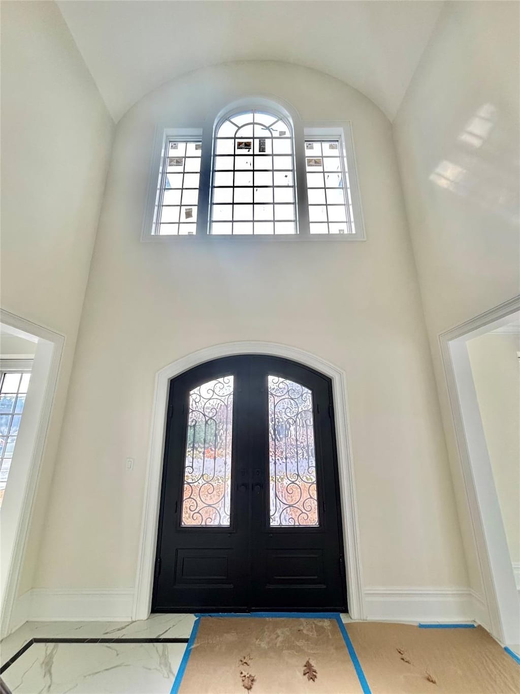 entrance foyer with french doors and a high ceiling