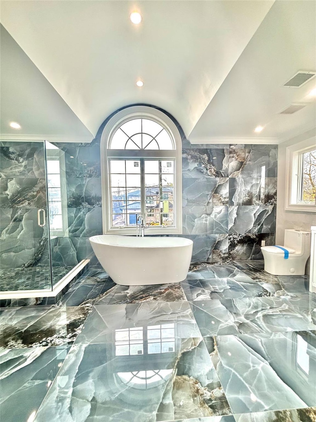 bathroom featuring separate shower and tub