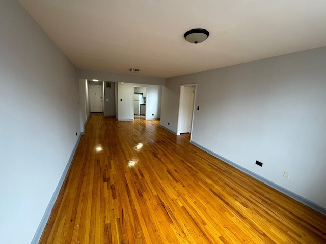 spare room featuring wood-type flooring