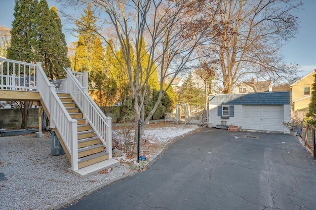 view of yard with an outbuilding, a garage, and a wooden deck