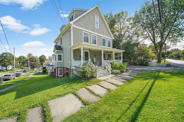 view of front of home with a porch and a front yard