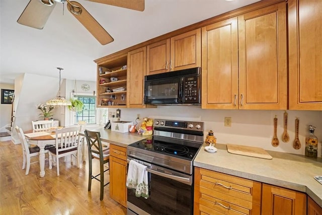 kitchen featuring electric stove, ceiling fan, light hardwood / wood-style floors, and decorative light fixtures