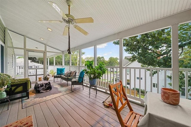 sunroom / solarium featuring ceiling fan