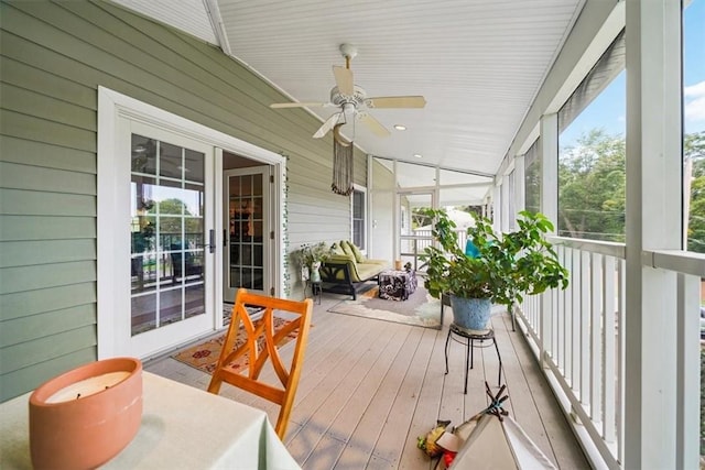 sunroom featuring ceiling fan and lofted ceiling