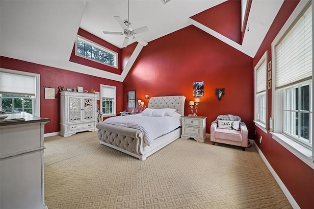 bedroom with carpet, multiple windows, high vaulted ceiling, and ceiling fan