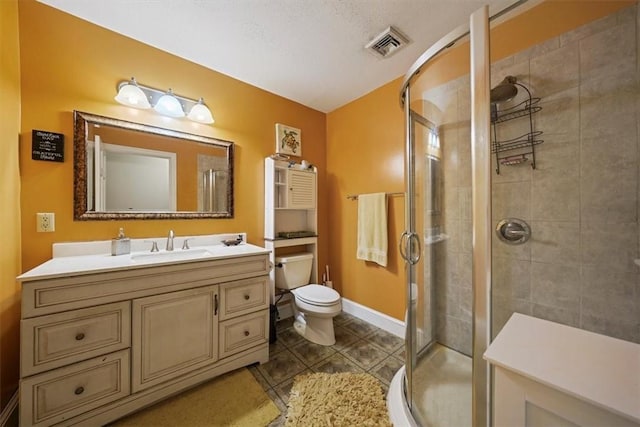 bathroom with walk in shower, a textured ceiling, vanity, tile patterned flooring, and toilet