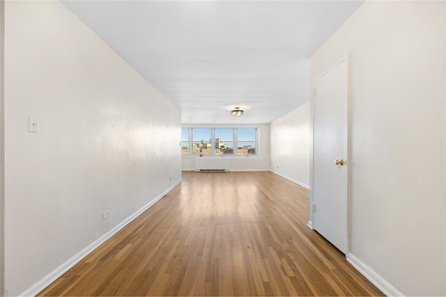 corridor with light hardwood / wood-style flooring