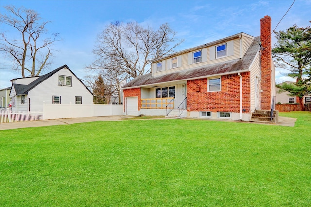 rear view of house featuring covered porch, a yard, and a garage