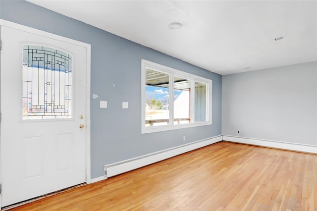 entrance foyer featuring hardwood / wood-style floors and a baseboard radiator