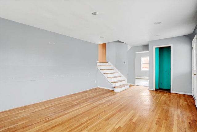 spare room with light hardwood / wood-style floors and baseboard heating