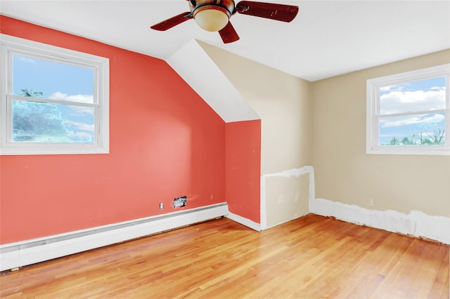 bonus room with ceiling fan, vaulted ceiling, baseboard heating, and light hardwood / wood-style flooring